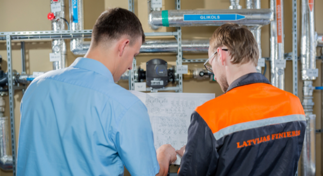 Two men looking at a blueprint