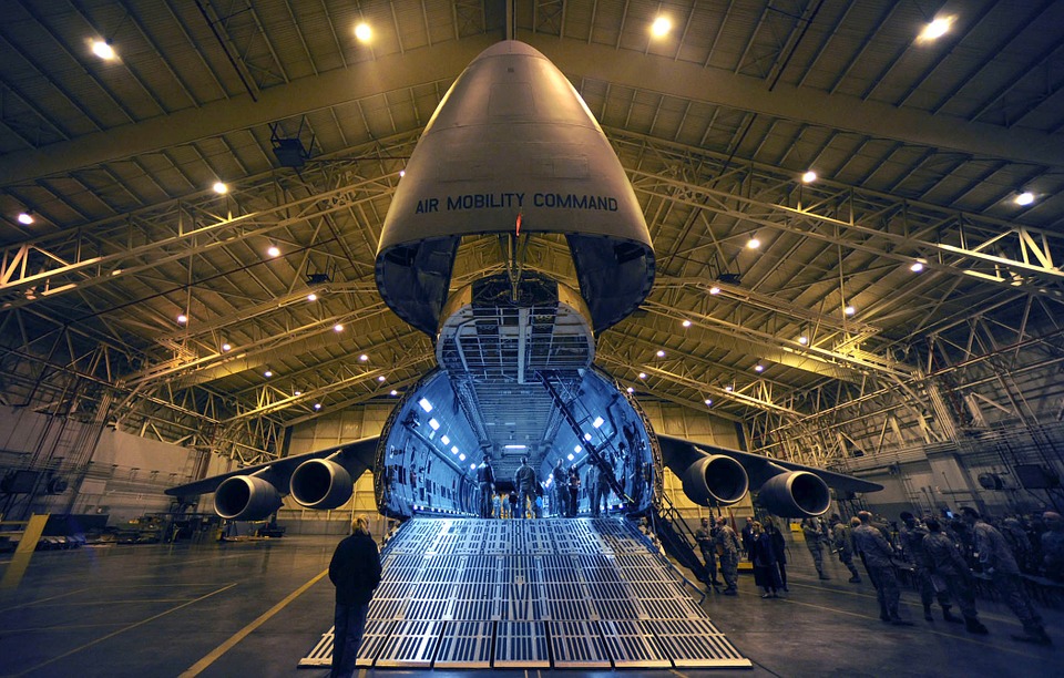 People exploring the front of an airplane opened up